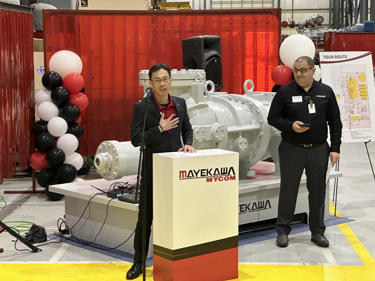 Tomo Hashimoto, CEO of Mayekawa USA, speaks at the company’s open house in Katy. Majed Abdeljawad, vice president of manufacturing, is at right.